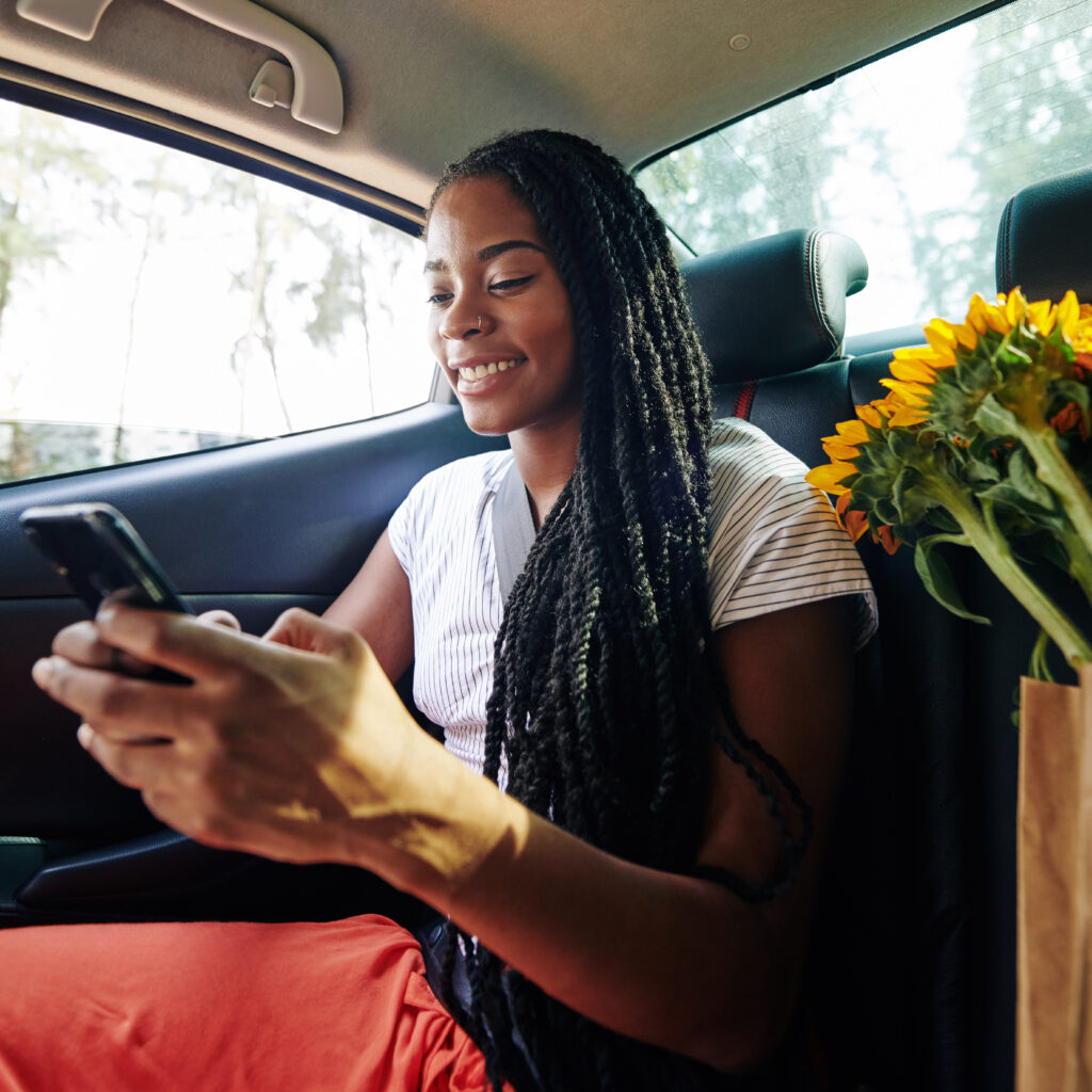 Texting teenager in back seat of a car